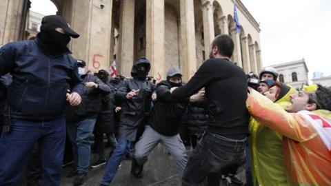 : Protesters, staging protest, clash with police officers as they endeavor to breach the security perimeter of the Georgian Parliament building following the announcement of the voting outcomes for 'transparency of foreign influence' bill in Tbilisi, Georgia on May 14, 2024.