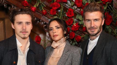 From left to right: Brooklyn Beckham, Victoria Beckham and David Beckham.