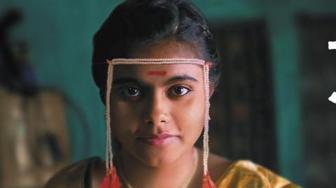 A still from Sthal: A Match shows the lead character played by Nandini Chikte  sitting on a wooden stool 