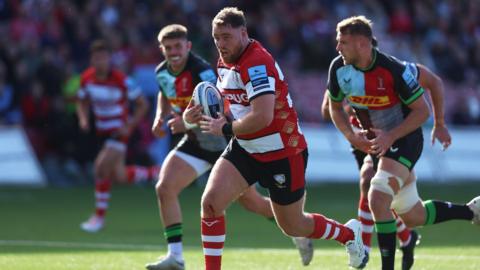 Harry Elrington running with the ball as Gloucester played Harlequins earlier this season