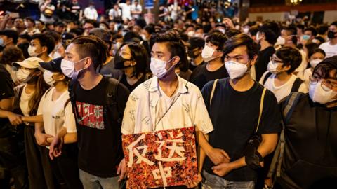 Protesters occupy a street after a rally against the extradition law proposal at the Central Government Complex on June 10, 2019