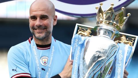 Pep Guardiola with the Premier League trophy