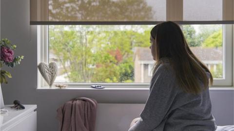 Woman looking out of window