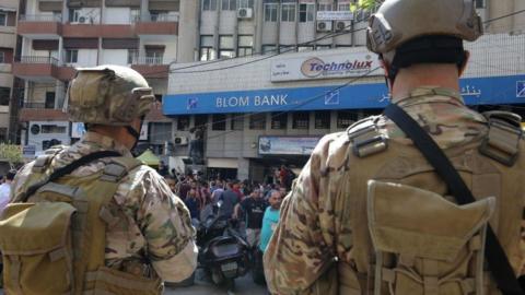 Security forces outside a bank