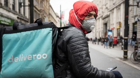 Deliveroo driver wearing a mask in Cardiff, Wales