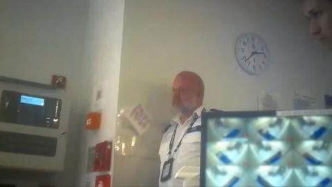 A police officer against the wall.