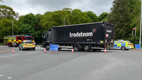 The scene of a police incident where a collision between a car and lorry has taken place. 