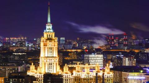 Pictures of hotel building with tall tower at night time