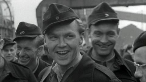 Smiling German soldiers as they get ready to leave