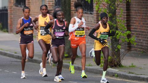 Competitors including Tigist Ketema, Tigst Assefa, Joyciline Jepkosgei, Yalemzerf Yehualaw, Peres Jepchirchir in action just past the mile 16 stage in the women's elite race during the TCS London Marathon