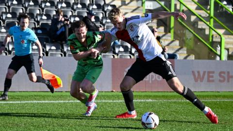 Jokubas Mazionis, right, in action for Woking against Forest Green