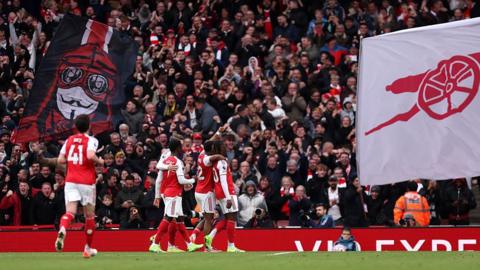 Arsenal players celebrate a goal with supporters