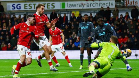 Josh Windass of Wrexham scores the opening goal