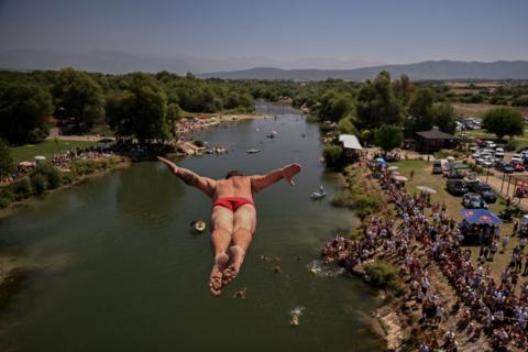 A diver jumps from a 22-metre-high bridge into the White Drin River during a traditional high diving competition near the town of Gjakova. Photo by Armend Nimani