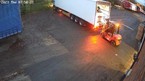 The yard where the incident happened. A forklift truck can be seen at the back of a lorry.