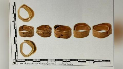 The ring seen from seven different angles reproduced in a graph with a ruler to show the size of each component part. 