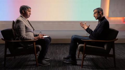 Faisal Islam looks at Sundar Pichai as he speaks during the interview.