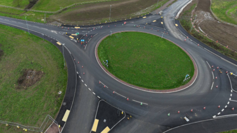 An aerial picture of a roundabout without any traffic