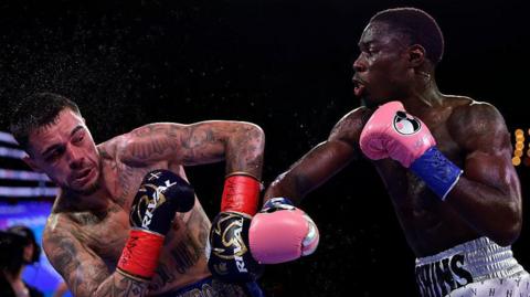 Richardson Hitchins throws a punch at George Kambosos Jr during their fight in June 2025