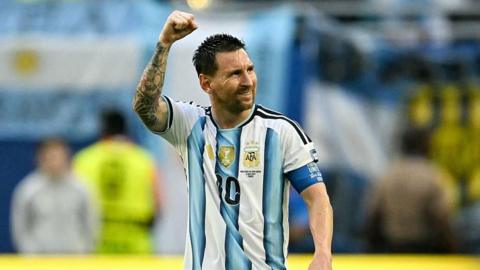 Lionel Messi raises his fist to the air