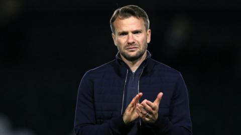 Tom Cleverley claps his hands after a match