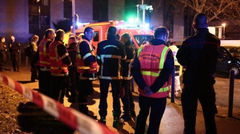 Emergency services can be seen at a scene of an explosion at a bar in Grenoble.