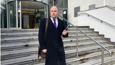 Man walking down the steps of court