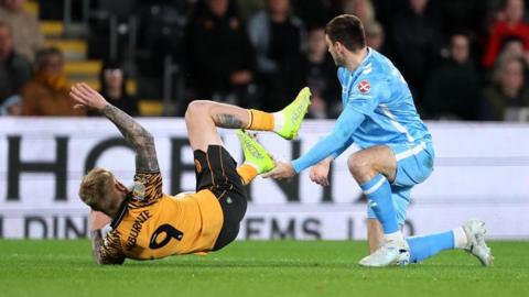 Hull striker Oli McBurnie takes a tumble