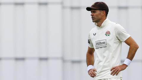 James Anderson stands with his hands on his hips