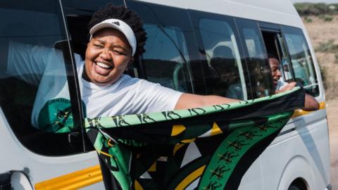 A supporter holds a flag of the newly formed uMkhonto weSizwe (MK) party as hundreds of supporters gather to celebrate in Kwaximba on June 02, 2024