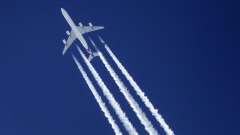 Plane with contrails