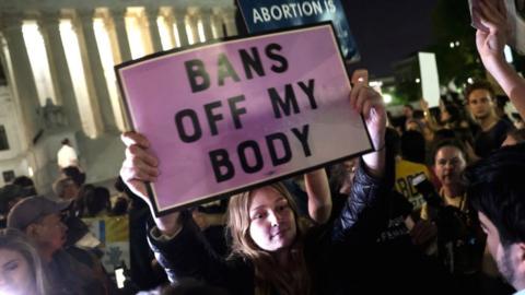 Demonstrators gather outside of the Supreme Court on Monday night