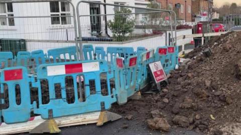 Road dug up for repairs to water main