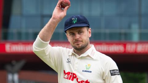 Mason Crane holds up the red ball
