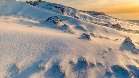Ingleborough summit in snowy conditions