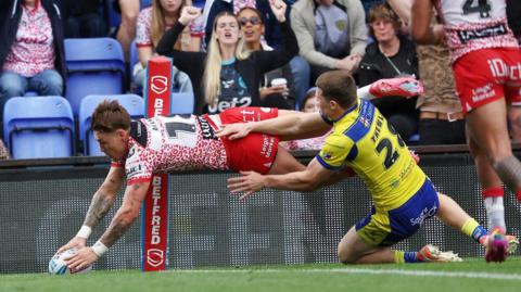 Leigh Leopards' Keanan Brand scores a try against Warrington