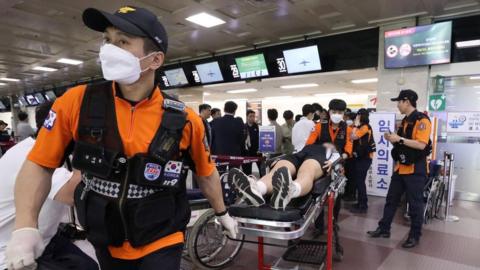 A passenger from the A321-200 Asiana Airlines flight put on a stretcher at Daegu International Airport