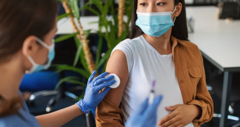 A pregnant woman having an injection