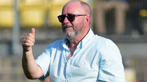 Torquay United manager Gary Johnson gives a thumbs up to the fans