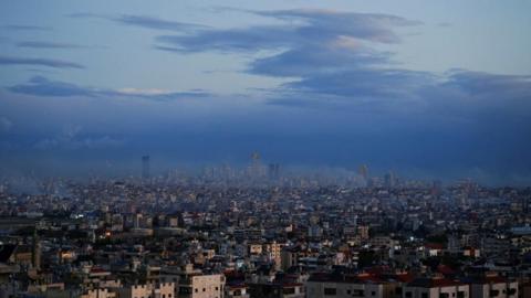 A view of Beirut's southern suburbs and its surroundings, with smoke rising from Israeli strikes that occurred before the ceasefire, as seen from Deir Qoubel