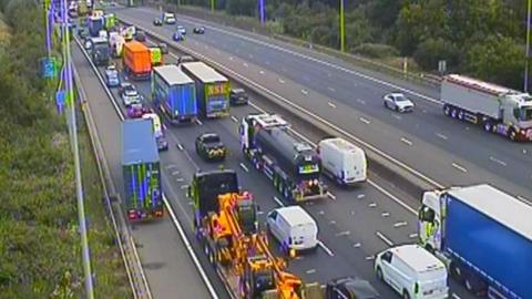 A queue of traffic spanning four lanes of a motorway