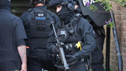 Several armed police officers in full kit at the Whitehawk Road incident.