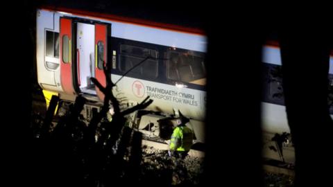 Train carriage in the dark on track with doors open