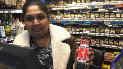 Shiyam Gunawardena holding a can of wasp killer