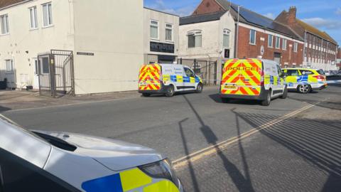 Police vehicles outside a property