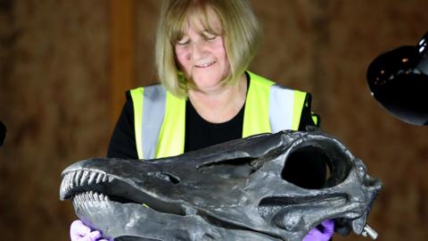 Museum technician holds Dippy's 'skull'