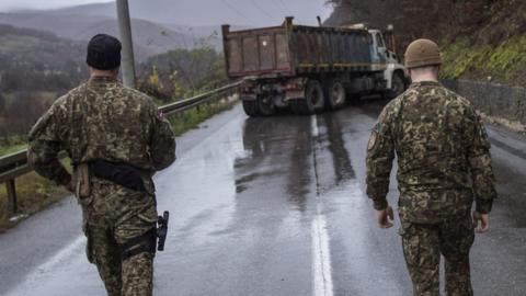 Two soldiers and a truck