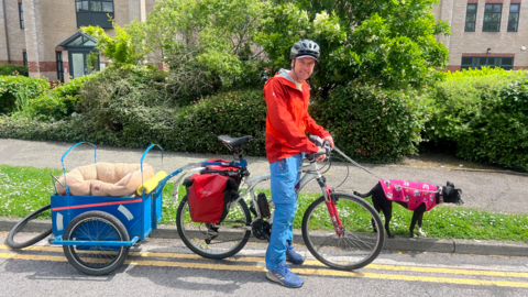 John Vincent on his bike with dog Akela