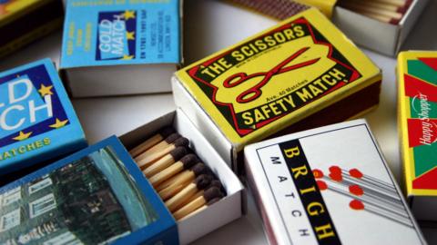 Several boxes of matches, with some open showing the matchsticks.