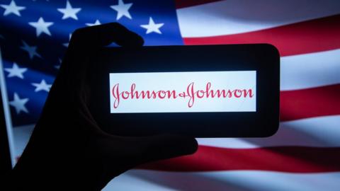 Johnson & Johnson logo in front of US flag